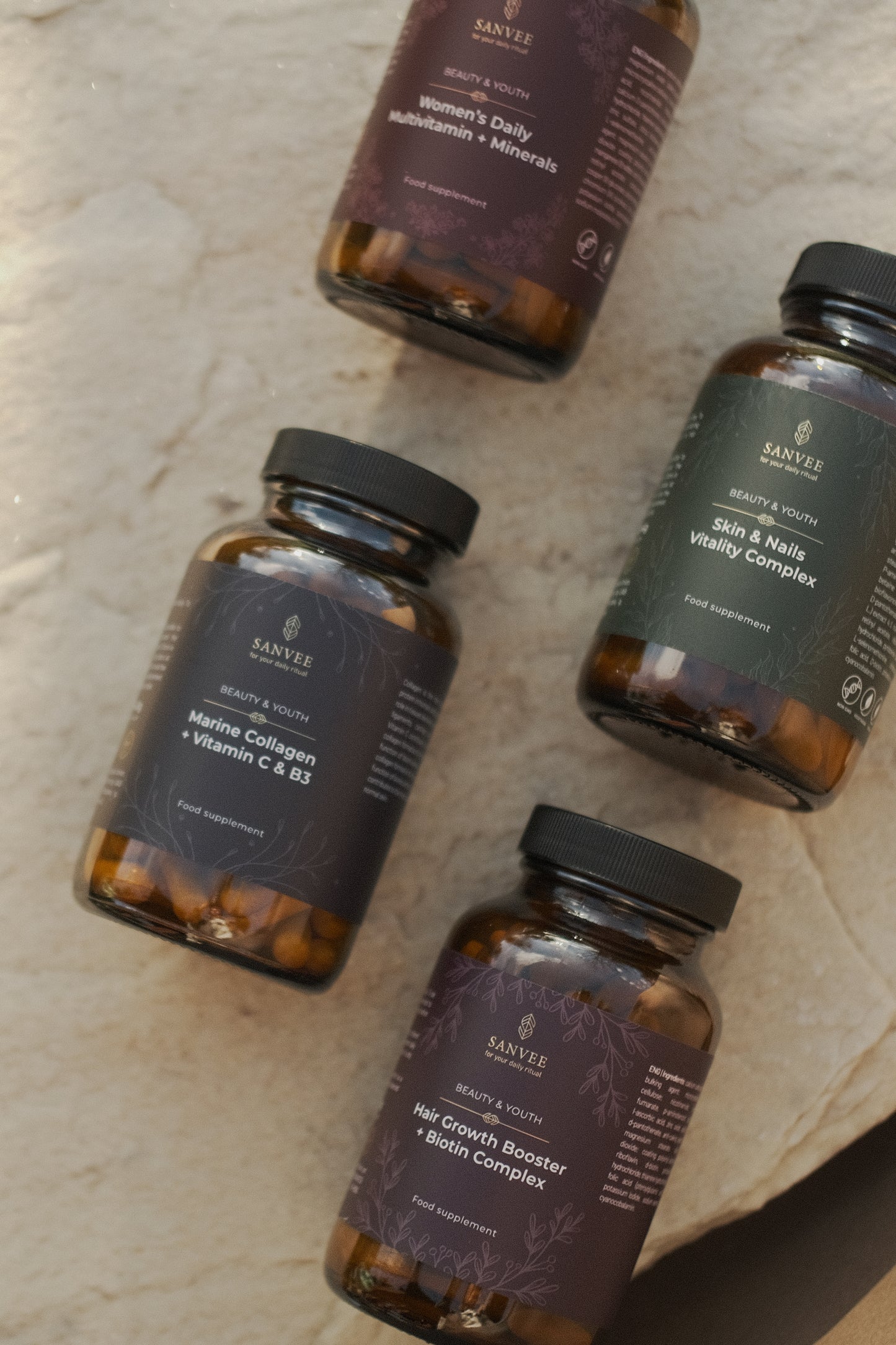 Sanvee supplement bottles including marine collagen vitamin c and skin and nails vitality complex on natural surface